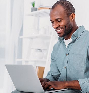 a man sitting in front of a laptop computer